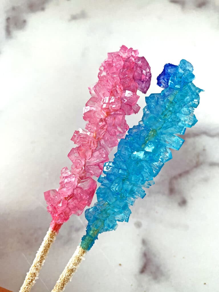 Pink and blue rock candy made from re-used sugar solution after adding more sugar to it