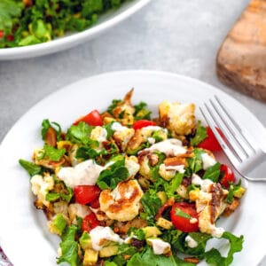 Roasted Cauliflower BLT Salad -- This Roasted Cauliflower BLT Salad uses kale instead of lettuce and also includes avocado and a creamy lemon dressing... It's enough to turn anyone into a cauliflower fan! | wearenotmartha.com