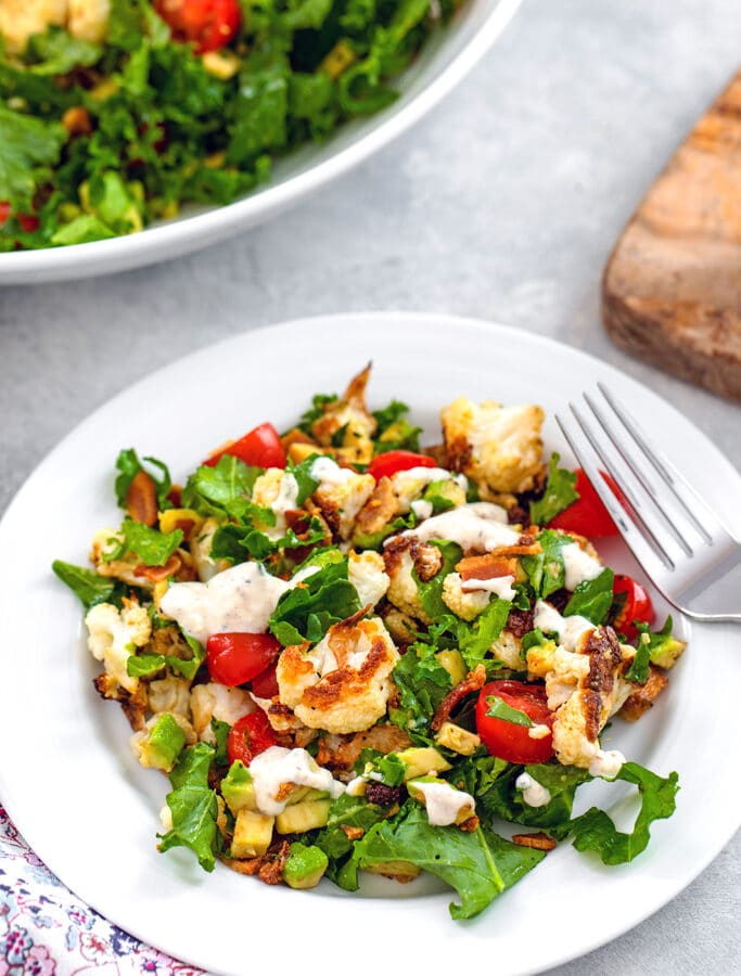 Roasted Cauliflower BLT Salad -- This Roasted Cauliflower BLT Salad uses kale instead of lettuce and also includes avocado and a creamy lemon dressing... It's enough to turn anyone into a cauliflower fan! | wearenotmartha.com