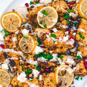 Roasted Cauliflower Salad with Lemons, Pomegranate, and Feta -- Stop hiding cauliflower in your smoothies and let it act as the star with this Roasted Cauliflower Salad with Lemon, Pomegranate, and Feta with Tahini Dressing | wearenotmartha.com