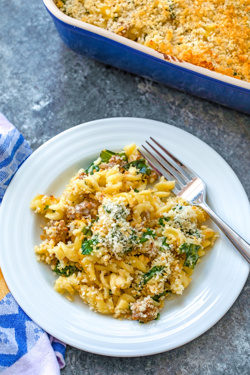Roasted Garlic Mac and Cheese with Sausage and Kale -- If you're looking to take the typical mac and cheese up a few levels, try this Roasted Garlic Mac and Cheese with Sausage and Kale. With two types of cheese, lots of sausage, roasted garlic, and fresh kale, this mac and cheese is the ultimate comfort food! | wearenotmartha.com #macandcheese #roastedgarlic #sausage #comfortfood