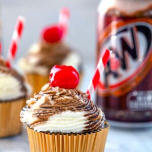 Root Beer Float Cupcakes -- Soda craving? These Root Beer Float Cupcakes topped with a whipped cream frosting and root beer syrup (and a cherry, obviously) will totally hit the spot | wearenotmartha.com
