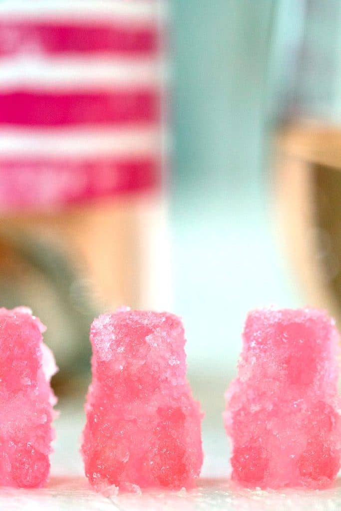 Head-on closeup of three pink rosé sour patch kids