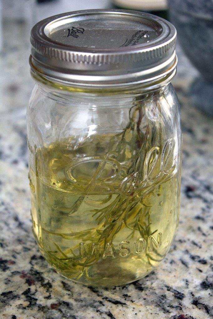 Head-on view of a mason jar filled with rosemary simple syrup