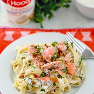 Salmon Fettuccine with Sour Cream Caesar Sauce – This deliciously creamy salmon pasta dish is packed full of flavor thanks to a caesar sauce made with Hood Sour Cream, lots of fresh herbs, and bacon. It’s incredibly easy to make and will be on your table in no time! | wearenotmartha.com