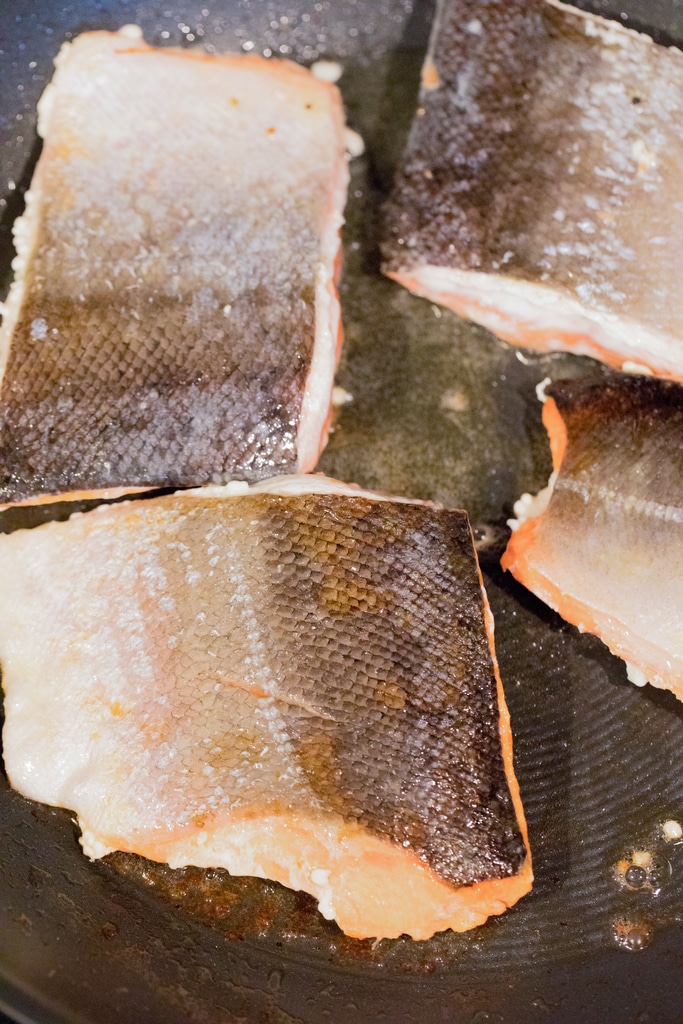 Salmon skin-side-up in skillet