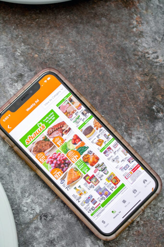 Overhead view of iPhone with Shaw's Supermarket app open