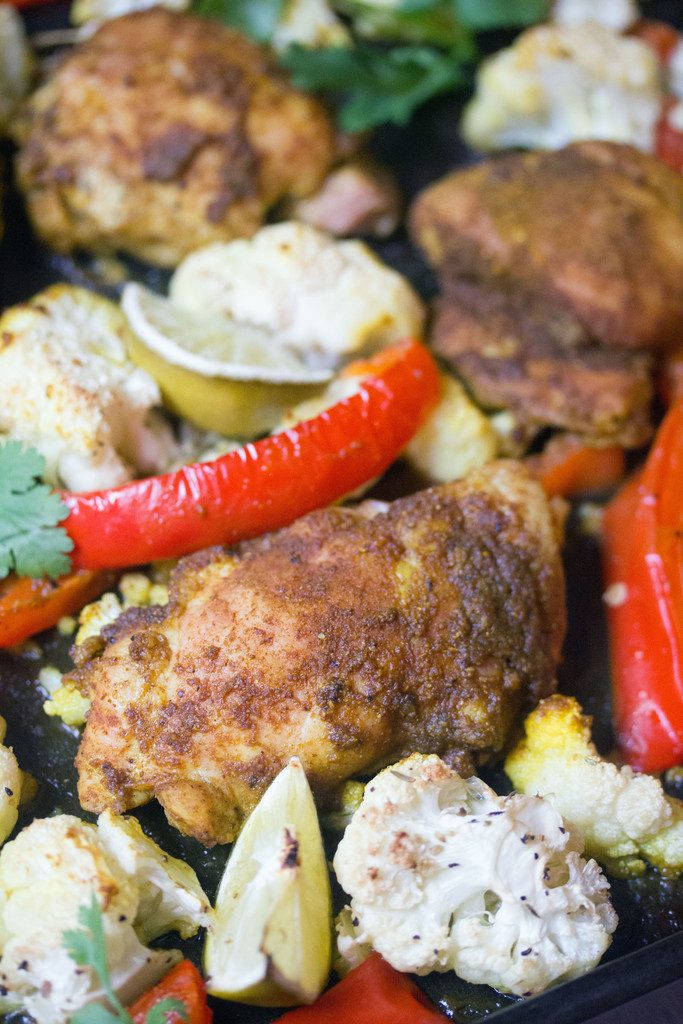 Sheet Pan Curry Chicken Thighs -- a sheet pan dinner with cauliflower and peppers, served with naan and yogurt sauce! | wearenotmartha.com