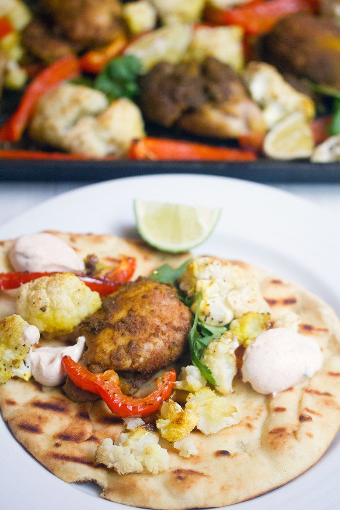 Sheet Pan Curry Chicken Thighs -- a sheet pan dinner with cauliflower and peppers, served with naan and yogurt sauce! | wearenotmartha.com