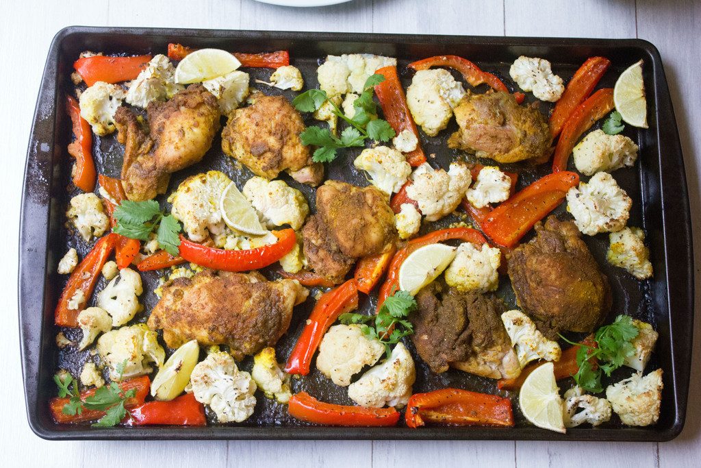 Sheet Pan Curry Chicken Thighs -- a sheet pan dinner with cauliflower and peppers, served with naan and yogurt sauce! | wearenotmartha.com