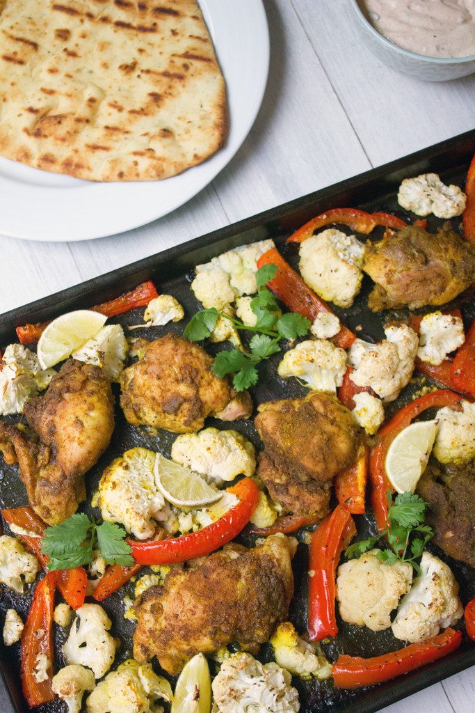 Sheet Pan Curry Chicken Thighs -- a sheet pan dinner with cauliflower and peppers, served with naan and yogurt sauce! | wearenotmartha.com