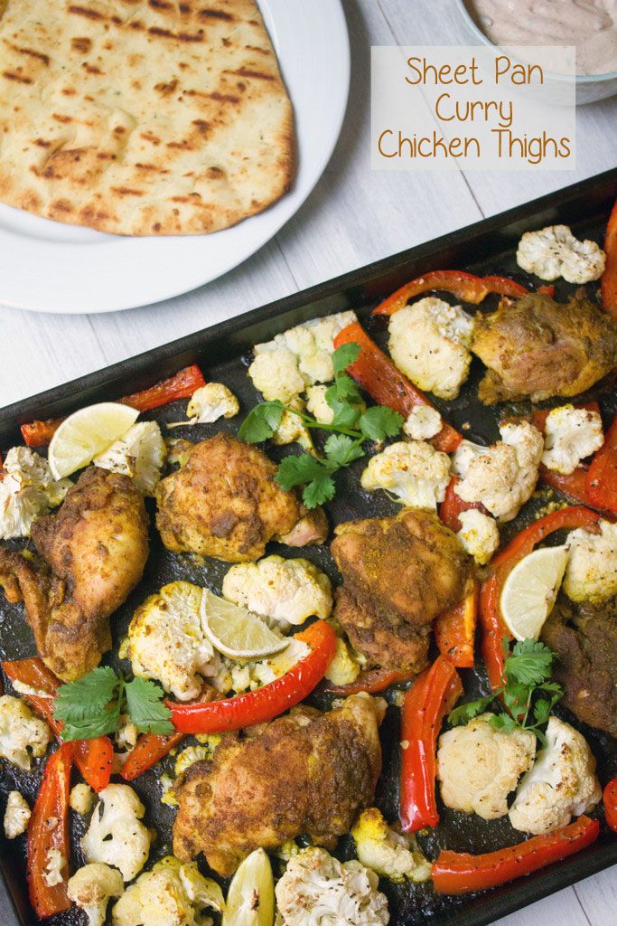 Sheet Pan Curry Chicken Thighs -- a sheet pan dinner with cauliflower and peppers, served with naan and yogurt sauce! | wearenotmartha.com