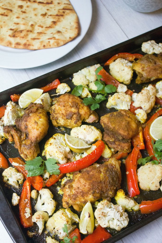 Sheet Pan Curry Chicken Thighs -- a sheet pan dinner with cauliflower and peppers, served with naan and yogurt sauce! | wearenotmartha.com