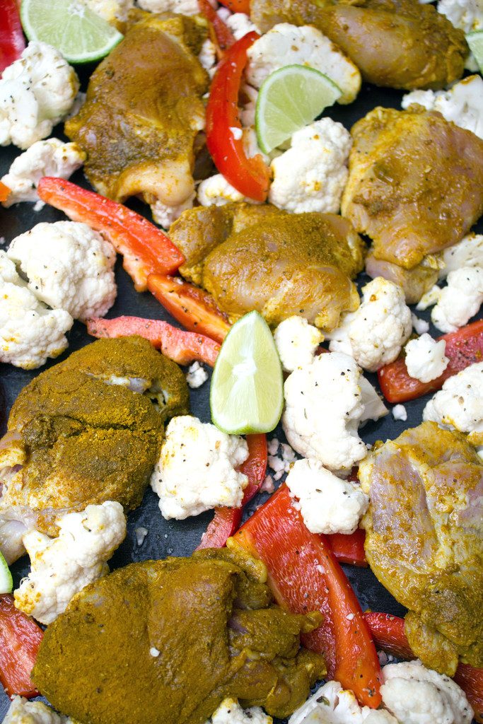 Sheet Pan Curry Chicken Thighs -- a sheet pan dinner with cauliflower and peppers, served with naan and yogurt sauce! | wearenotmartha.com