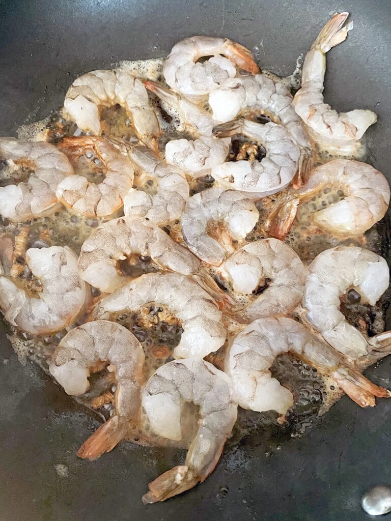 Shrimp added to butter in sauté pan