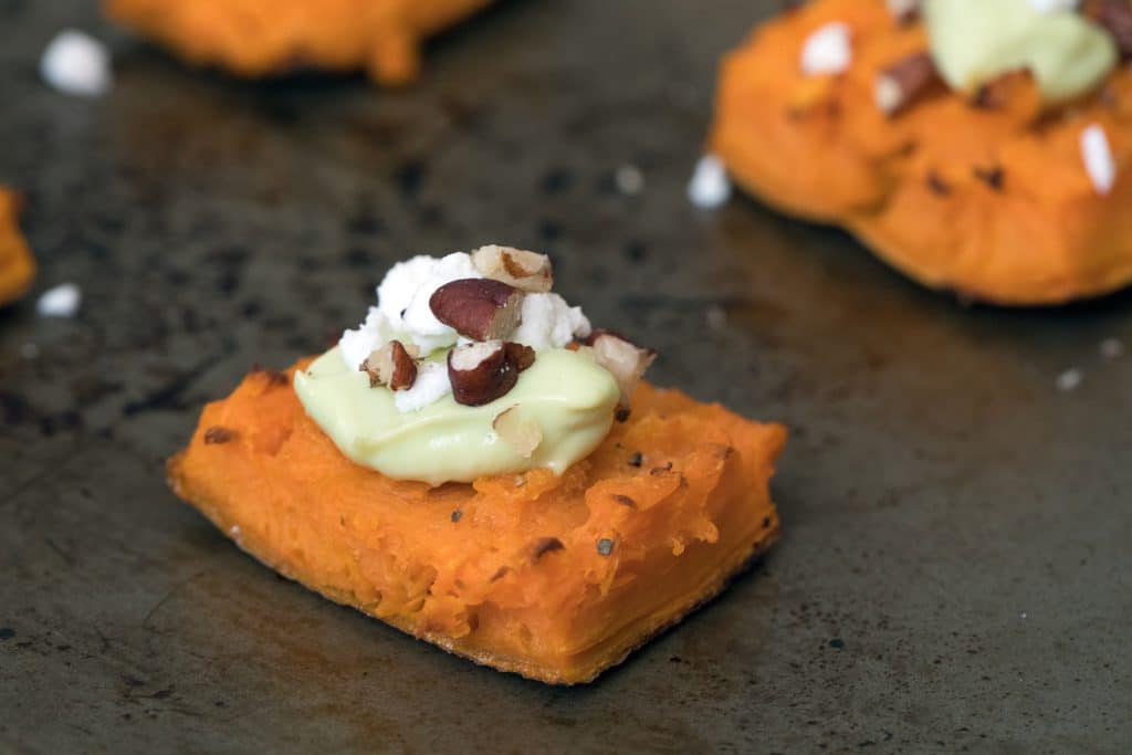 Smashed Sweet Potatoes -- The perfect fall appetizer or side dish, topped with Maple Avocado Crema, goat cheese, and pecans | wearenotmartha.com