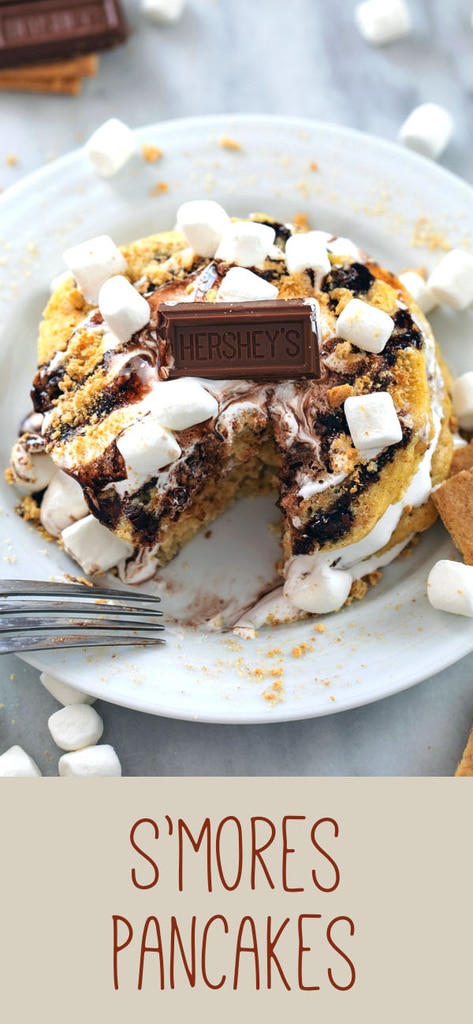 S'mores Pancakes -- Whether you need a little Sunday morning indulgence or are taking breakfast for dinner to new levels, these S'mores Pancakes packed with graham cracker flavor, homemade marshmallow fluff, and chocolate sauce are sure to make your whole family happy | wearenotmartha.com