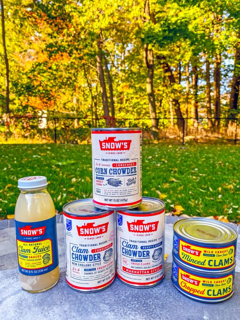 Cans of Snow's clam chowders, clam juice, and minced and chopped clams