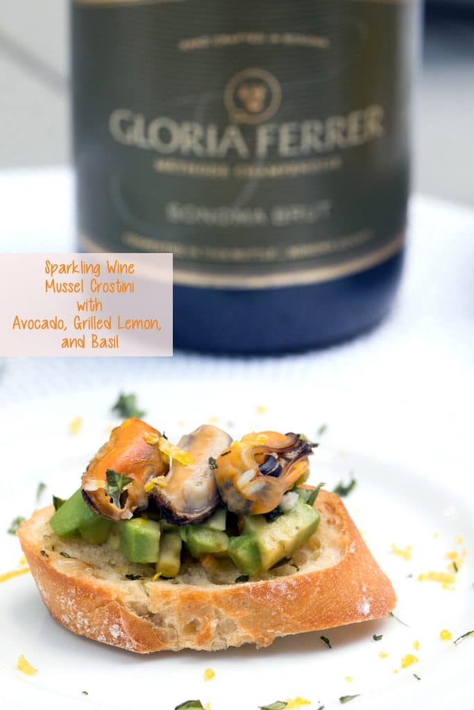 Sparkling Wine Mussel Crostini with Avocado, Grilled Lemon, and Basil -- The perfect party appetizer #GloriousBites | wearenotmartha.com