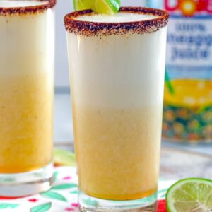 Spiced Pineapple Cocktail -- This Spiced Pineapple Cocktail is a tequila-based drink packed with fresh pineapple and pineapple juice, a little bit of citrus, and a spicy kick from the spiced rim of the glass | wearenotmartha.com
