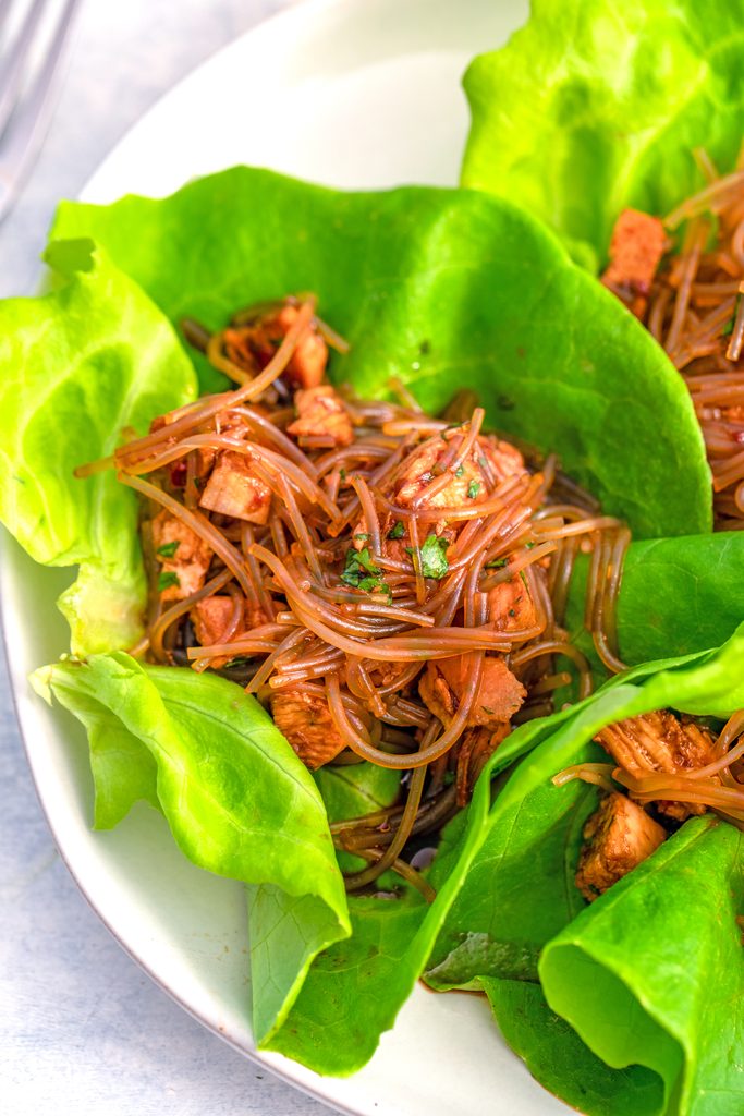 Overhead close-up of a spicy Asian lettuce wrap on a plate