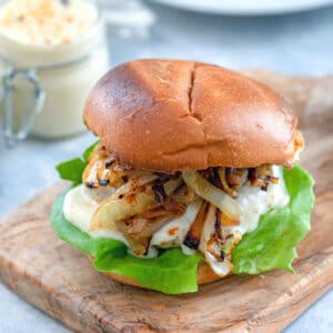 Spicy Cheesy Chicken Burgers -- Chicken burgers don't have to be boring! This Spicy Cheesy Chicken Burger is packed with a flavorful kick, covered in a delicious cheese sauce, and served on a toasted brioche bun | wearenotmartha.com