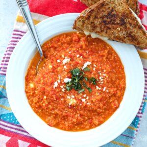 Spicy Roasted Tomato Soup with Quinoa and Feta -- This spicy tomato soup was inspired by Panera's tomato soup, but is taken to a new level with a little bit of spiciness, satisfying protein from quinoa, and extra delicious flavor from feta cheese | wearenotmartha.com