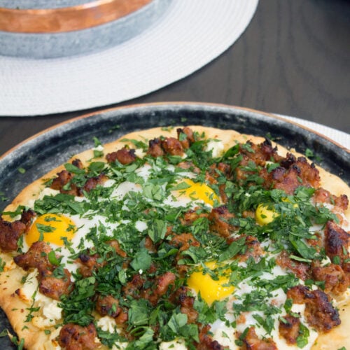 Spicy Sausage Pizza with Feta and Parsley -- And don't forget the eggs on top! | wearenotmartha.com