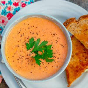 In need of some serious comfort food? This Spicy Tomato Soup made with canned diced tomatoes and served with a grilled cheese sandwich is exactly the meal you're looking for!