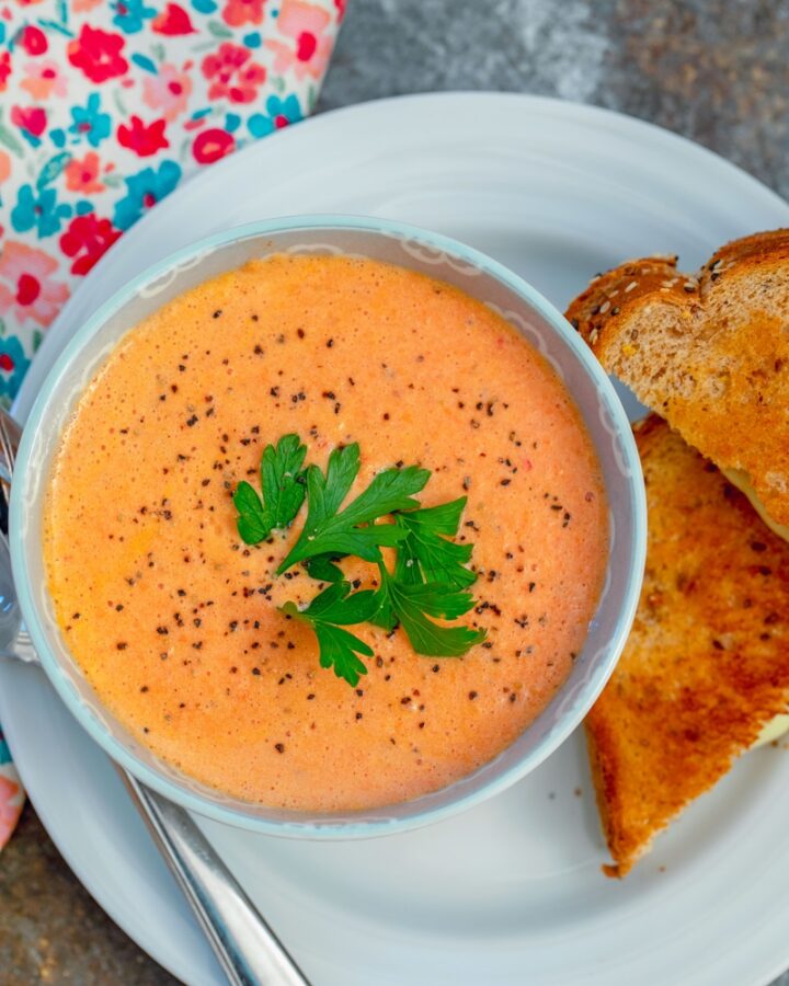 In need of some serious comfort food? This Spicy Tomato Soup made with canned diced tomatoes and served with a grilled cheese sandwich is exactly the meal you're looking for!