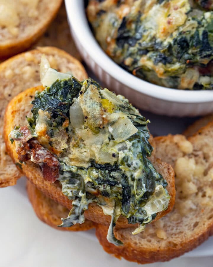 Every party needs a dip and this Spinach, Onion, and Bacon Dip will be the hit of any party! Serve it hot with homemade garlic toasts and it's almost a guarantee your guests will be asking for the recipe.