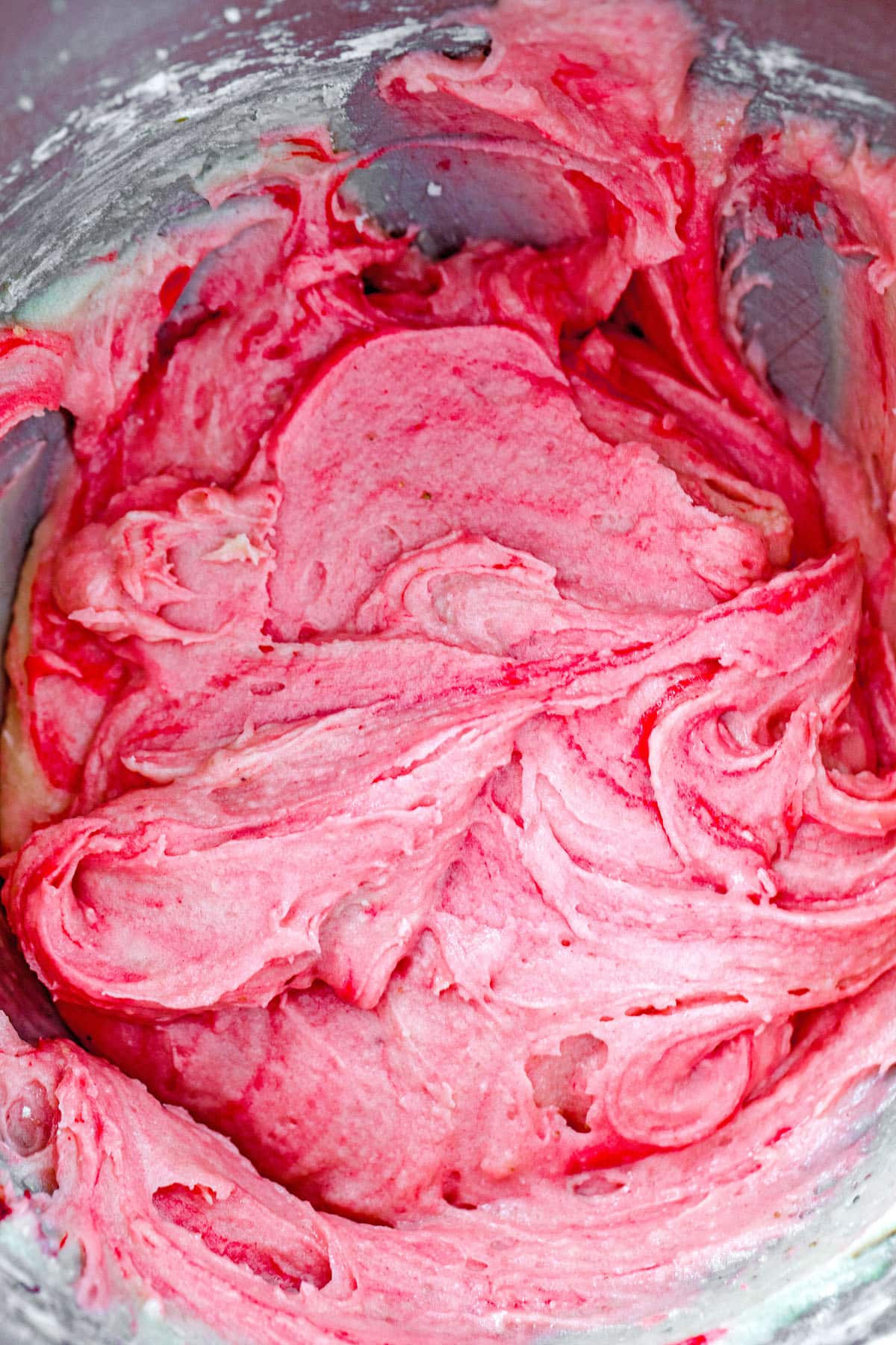 Pink strawberry cupcake batter in mixing bowl.