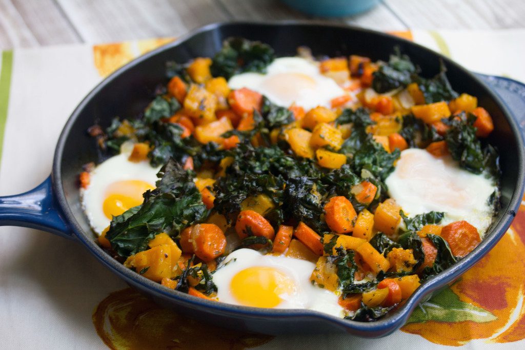 Landscape head-on closeup view of squash hash with kale and eggs