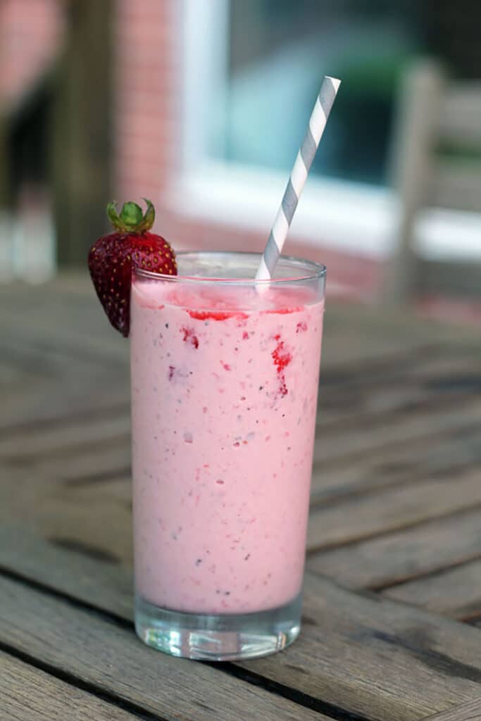 Head-on view of a strawberry mint milkshake.