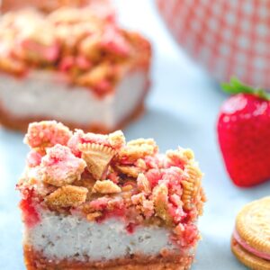 Strawberry Shortcake Cheesecake Bars -- These Strawberry Shortcake Cheesecake Bars are a delicious summer dessert perfect for BBQs or summer parties. They're packed with fresh strawberries and have a Strawberry Shortcake Oreo crust and crumble on top | wearenotmartha.com