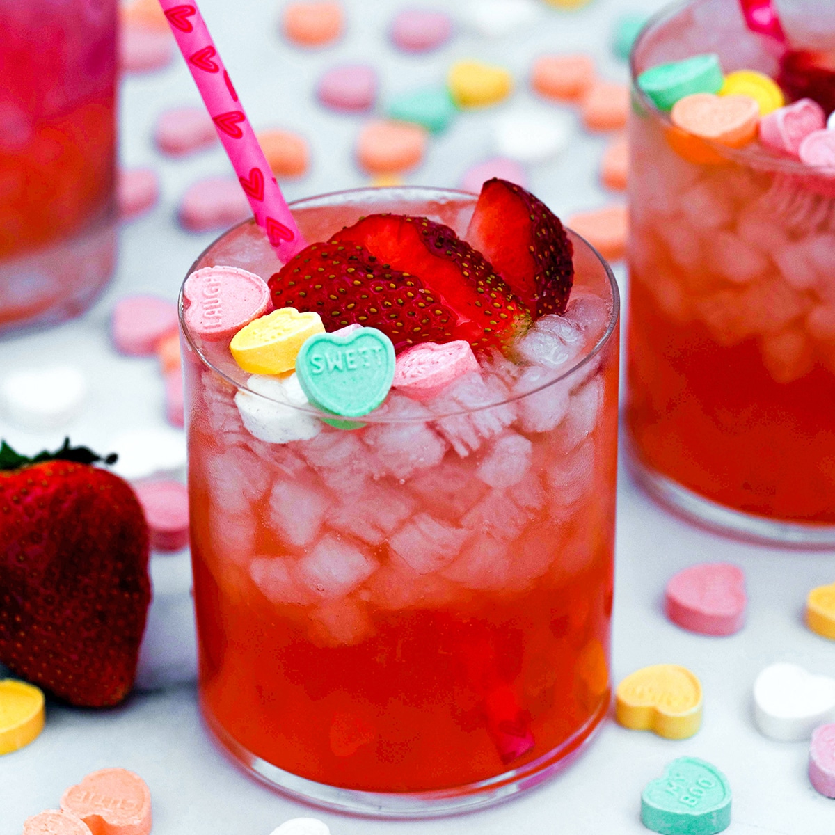 Looking for a love potion this Valentine's Day? Just add strawberry vanilla simple syrup, vodka, and lime juice for this Strawberry Vanilla Love Potion Cocktail! Top it with conversation hearts for February 14 or enjoy it with a loved one any day of the year.