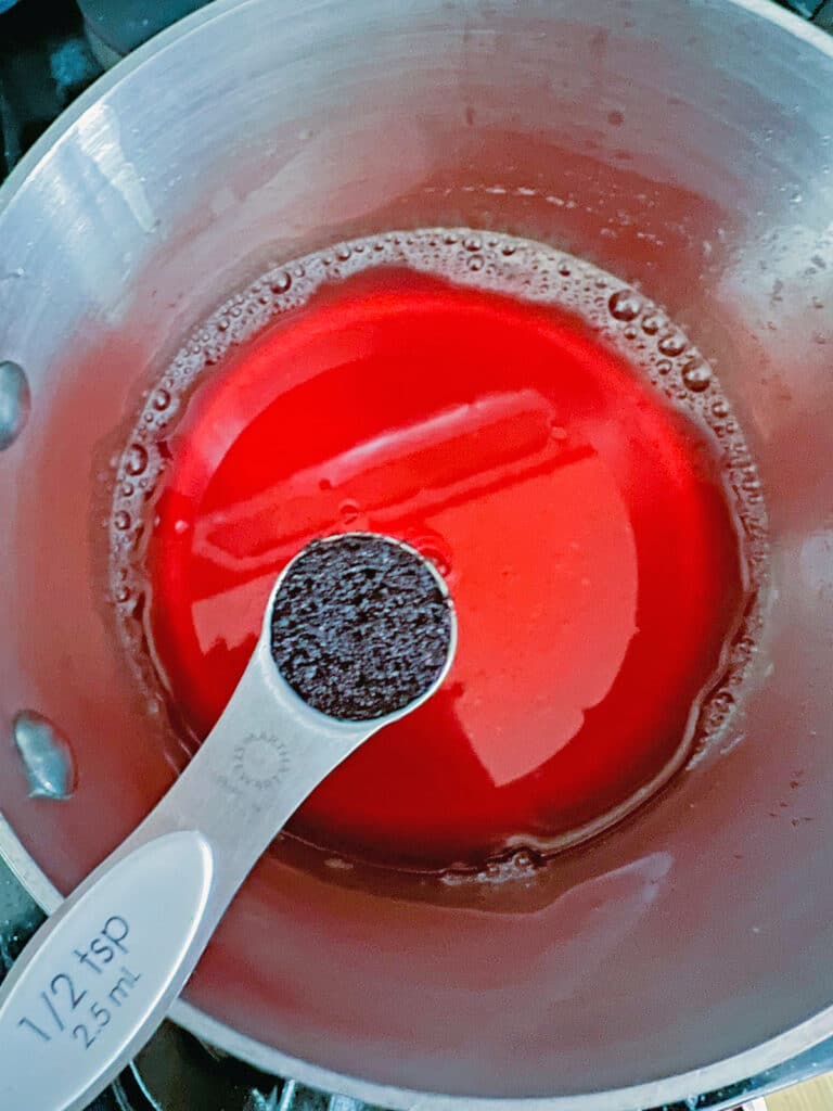 Strawberry grape juice with spoonful of acai powder over it.