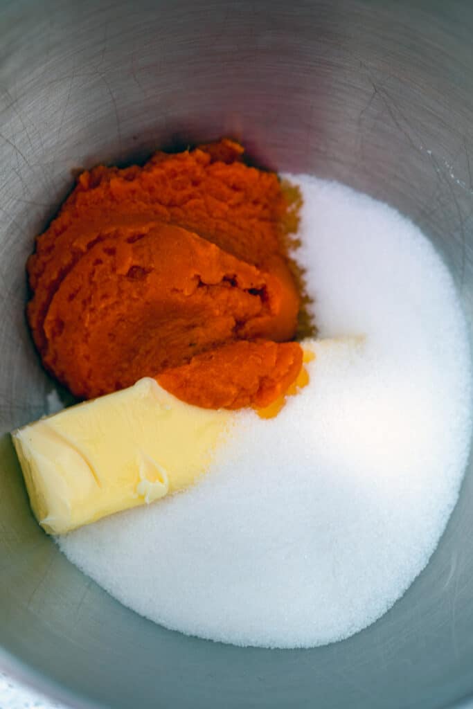 Butter, sugar, and pumpkin in a mixing bowl