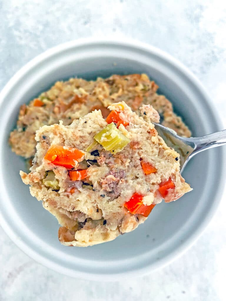 overhead view of a spoon holding a scoop of stuffing.