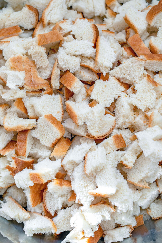 Torn up white bread in bowl.