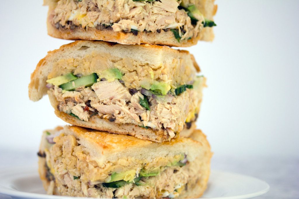 Tuna Nicoise Sandwich -- The layered sandwich includes tuna, eggs, avocado, chickpeas, and more! | wearenotmartha.com
