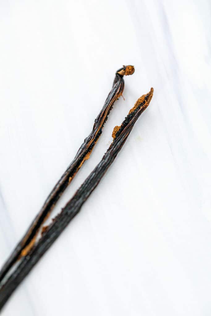 Vanilla beans on marble surface.