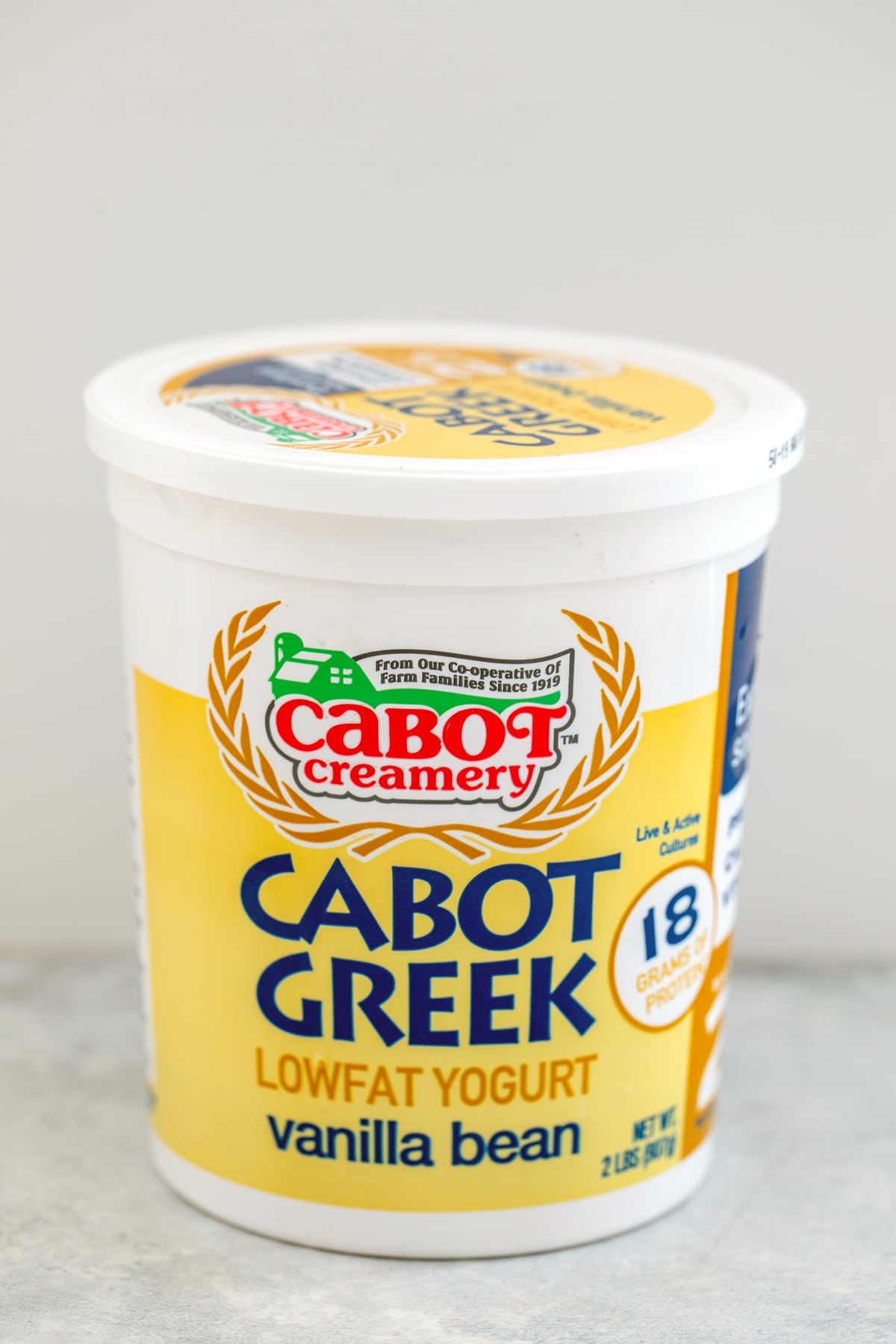 Head-on view of a container of Cabot vanilla bean Greek yogurt.