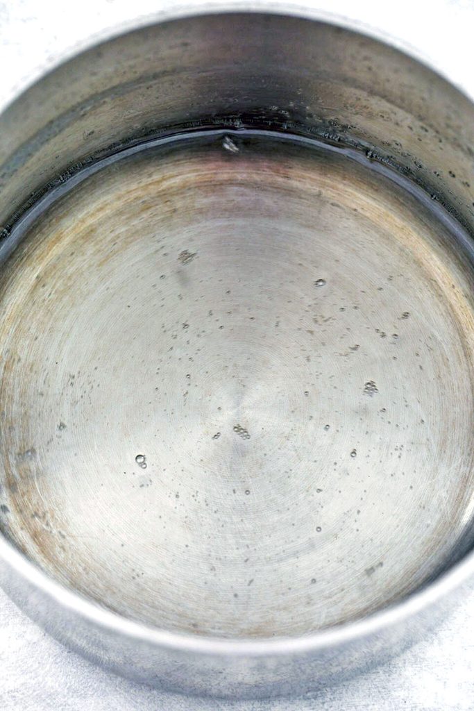 Overhead view of simple syrup simmering in saucepan