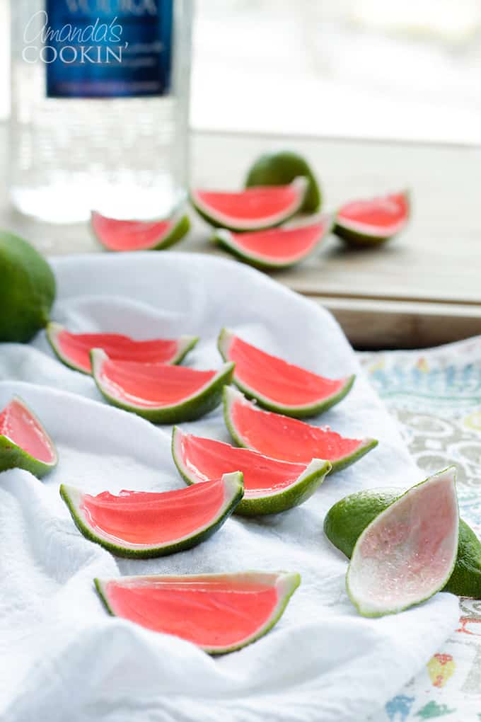 Lots of watermelon jello shots made in lime rinds