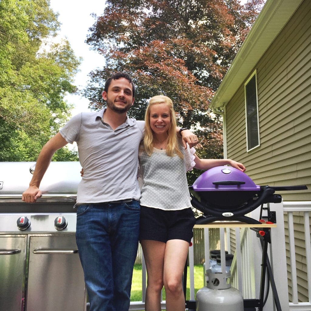 Chris and Sues in front of a purple Weber Q1200 grill