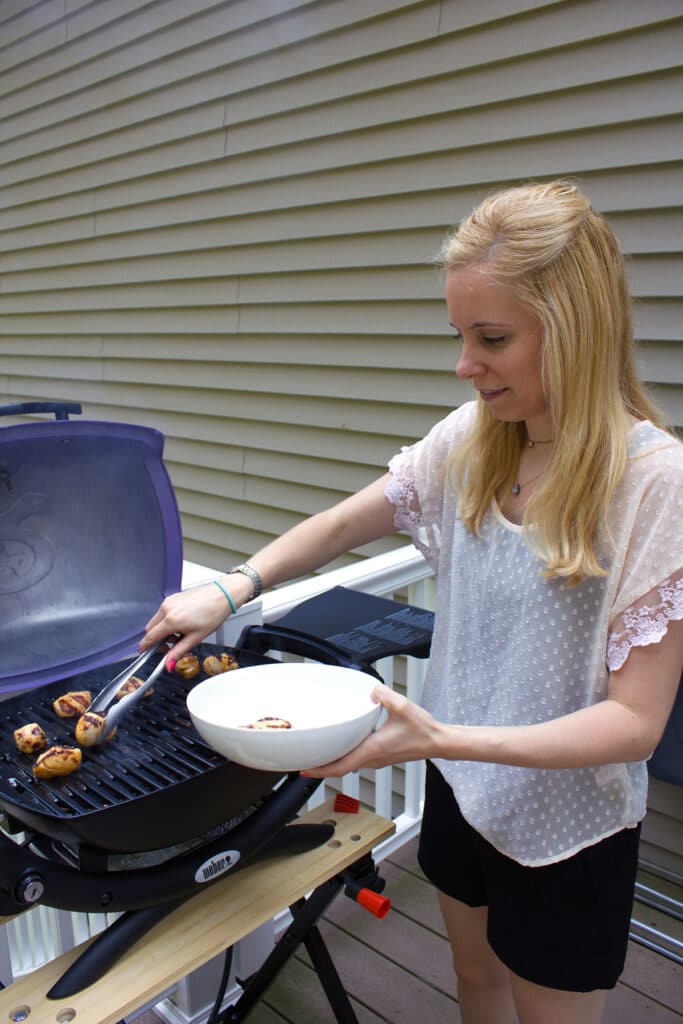 Susie putting scallops on grill