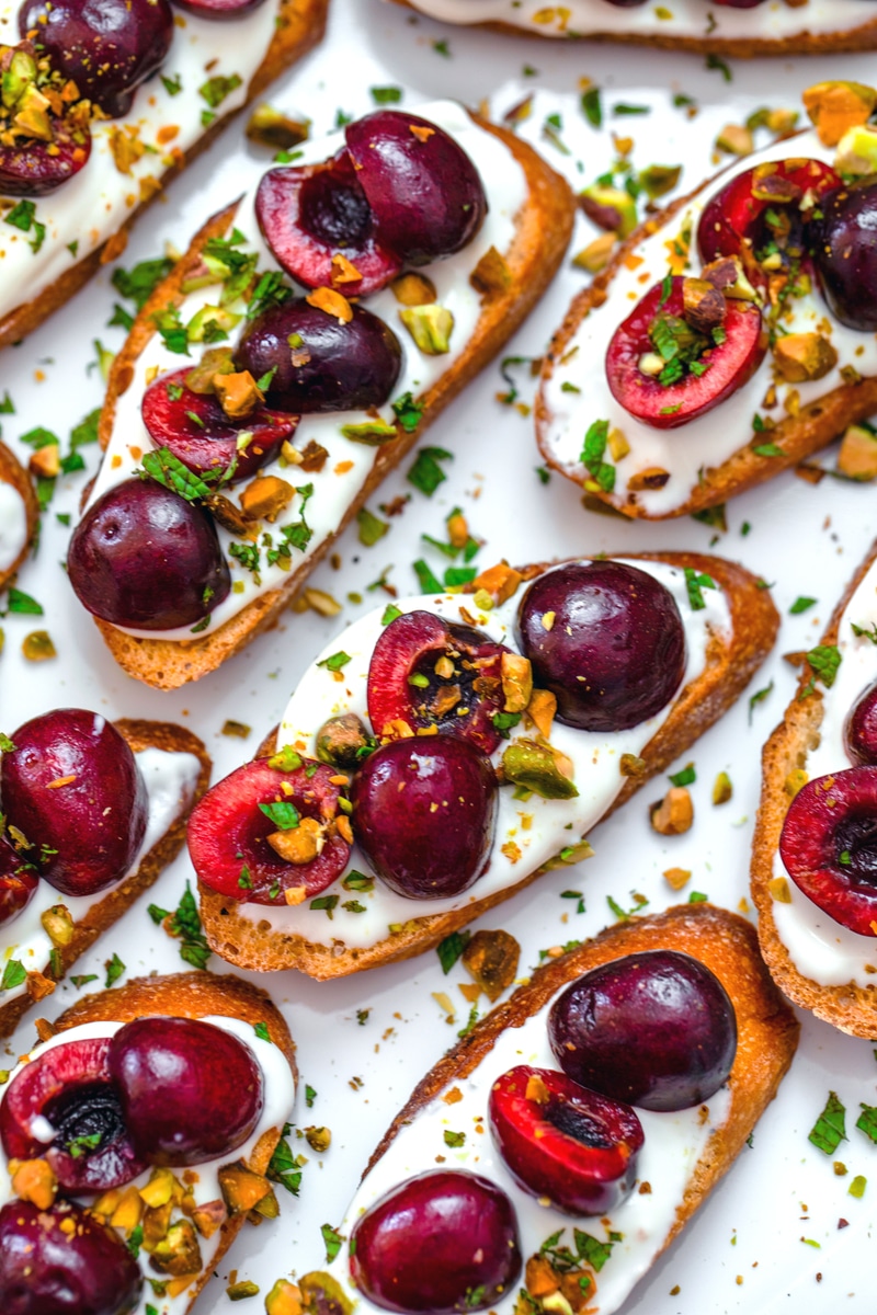 Whipped Ricotta and Cherry Crostini -- Looking for an easy but impressive summer appetizer? These Whipped Ricotta Cherry Crostini are quick and easy to prepare and will wow your guests! | wearenotmartha.com #crostini #partyappetizers #cherryrecipes #summerrecipes #appetizers