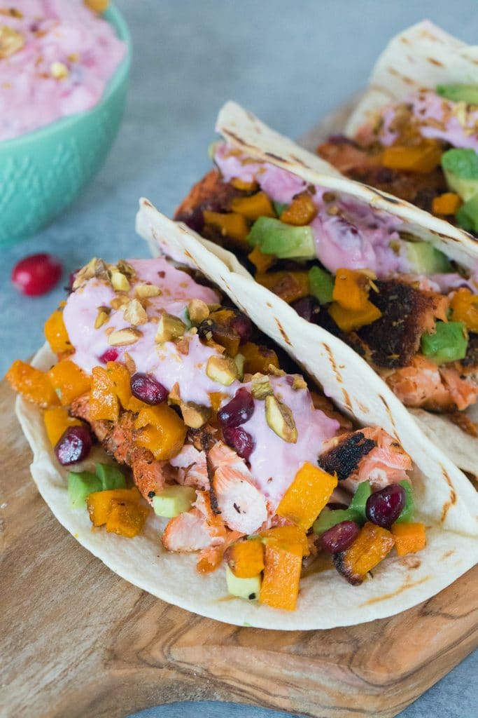 Winter Salmon Tacos with Butternut Squash Salsa and Cranberry Crema -- These fish tacos let you celebrate the winter season while sticking to a healthy eating plan! Packed with lots of winter flavors, algae oil is used to boost good fats | wearenotmartha.com