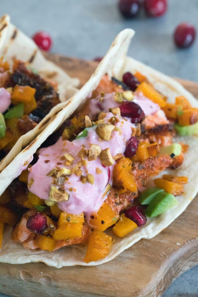 Winter Salmon Tacos with Butternut Squash Salsa and Cranberry Crema -- These fish tacos let you celebrate the winter season while sticking to a healthy eating plan! Packed with lots of winter flavors, algae oil is used to boost good fats | wearenotmartha.com